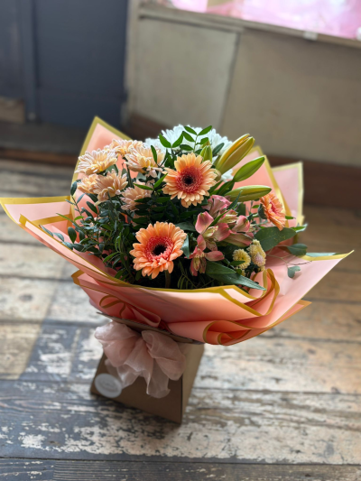 Peach Blossom - A delightful hand-tied bouquet featuring soft peach, blush pink, and creamy ivory tones, beautifully complemented by fresh seasonal greenery. Designed with a light and airy feel, this charming arrangement combines delicate textures and warm pastel shades to create an elegant and uplifting display.

Presented in stylish contemporary wrapping with a coordinating gift box, this bouquet is perfect for birthdays, thank-you gifts, new baby celebrations, anniversaries, or simply bringing a smile to someone's day.