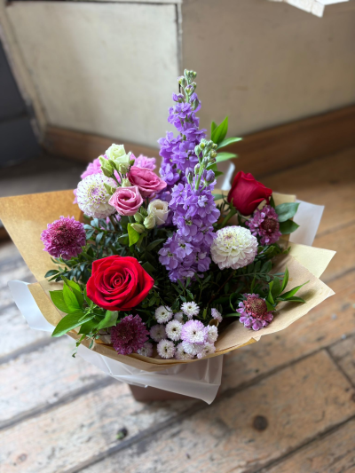 Ruby & Lavender - A striking hand-tied bouquet that beautifully combines rich ruby tones with soft lavender and blush accents, creating a design that feels both elegant and contemporary. Full of texture, colour, and seasonal charm, this arrangement is carefully crafted to make a lasting impression while maintaining a soft and graceful appeal.

Presented in stylish wrapping and a coordinating gift box, this bouquet is perfect for birthdays, anniversaries, celebrations, thank-you gifts, or any occasion where you want to send a thoughtful and memorable gesture.