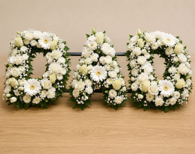 Loose Letters - A beautiful personalised letter tribute created to honour a loved one with elegance, dignity, and heartfelt remembrance. Designed in a timeless all-white palette, this handcrafted arrangement offers a graceful expression of sympathy and serves as a meaningful focal point during funeral and memorial services.

Each letter is carefully arranged with fresh seasonal blooms and delicate foliage, creating a refined and respectful tribute that celebrates a life cherished and never forgotten. Ideal for spelling initials, names, or special words that hold personal significance.