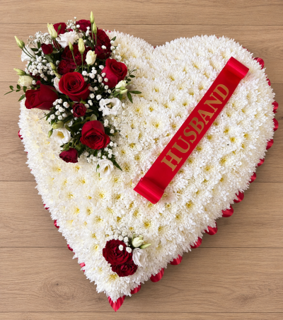 Heart - A touching heart-shaped funeral tribute created to honour the memory of a loved one. Featuring a classic white base accented with warm peach and orange tones, this elegant arrangement symbolises love, admiration, and the special bond that will never be forgotten.

Finished with a personalised ribbon this heartfelt design offers a meaningful expression of sympathy and remembrance. Handcrafted with care, it serves as a beautiful focal tribute at funeral services, memorial ceremonies, and celebrations of life.