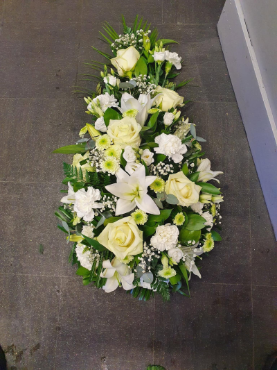 Teardrop Tribute - A graceful teardrop-shaped funeral tribute designed to express love, remembrance, and heartfelt sympathy. Featuring a serene palette of soft white and fresh green tones, this elegant arrangement creates a peaceful and comforting display, offering a meaningful farewell to a cherished loved one.

The teardrop shape symbolises eternal love and treasured memories, making it a thoughtful choice for funeral services, memorial ceremonies, or celebrations of life. Handcrafted with care, this tribute conveys respect, compassion, and lasting affection during a difficult time.
