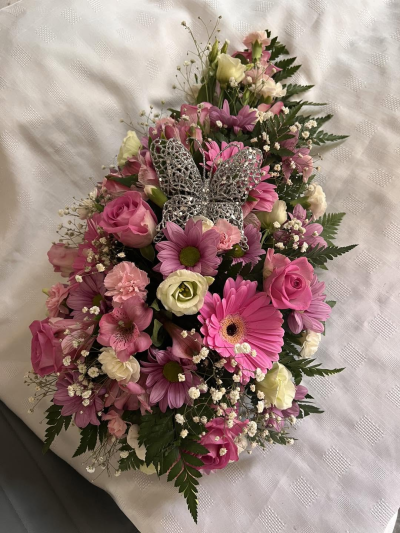Pink Teardrop - A beautiful teardrop-shaped funeral tribute in soft shades of pink and ivory, designed to celebrate a life filled with love, kindness, and treasured memories. Featuring a delicate butterfly embellishment as its focal point, this elegant arrangement symbolises transformation, hope, and the enduring presence of a loved one in our hearts.

Thoughtfully handcrafted, this graceful tribute offers comfort and heartfelt sympathy, making it a meaningful choice for funeral services, memorial ceremonies, or celebrations of life